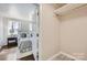 A secondary bedroom featuring hardwood floors, a window view, and a closet with shelves at 3210 Marlborough Rd, Charlotte, NC 28208