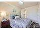 A comfortable bedroom with a gray and white comforter set and a view of the closet at 3210 Marlborough Rd, Charlotte, NC 28208