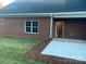 Brick home with back patio and grassy yard at 118 Abbington Ln, Shelby, NC 28150