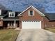 Brick home with a two-car garage and landscaping at 118 Abbington Ln, Shelby, NC 28150