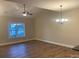 Bright living room with hardwood floors, large window, and ceiling fan at 118 Abbington Ln, Shelby, NC 28150