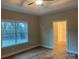 Main bedroom with hardwood floors, large window, ceiling fan, and en-suite bathroom at 118 Abbington Ln, Shelby, NC 28150