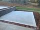 Concrete patio with retaining wall and landscaping at 118 Abbington Ln, Shelby, NC 28150