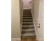 Carpeted staircase with wooden handrail leading upstairs at 118 Abbington Ln, Shelby, NC 28150