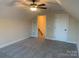 Spacious bedroom with ceiling fan, window, and access to upper level at 120 Abbington Ln, Shelby, NC 28150