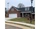 Brick ranch home with attached garage and landscaped lawn at 120 Abbington Ln, Shelby, NC 28150