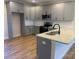 L-shaped kitchen with gray cabinets and granite countertops at 120 Abbington Ln, Shelby, NC 28150