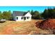 Newly constructed home with a white exterior, dark roof, and covered porch at - Beltline Rd # 10, Chester, SC 29706