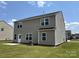 The back exterior features neutral siding, multiple windows, and a well-maintained lawn at 1009 Dawn Light Rd, Indian Trail, NC 28079