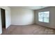 An inviting bedroom is carpeted and provides natural lighting from the window at 1009 Dawn Light Rd, Indian Trail, NC 28079