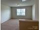 Versatile upstairs bonus room or loft area with neutral carpet and a window at 1009 Dawn Light Rd, Indian Trail, NC 28079
