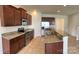 Modern kitchen with stainless steel appliances, granite countertops, and rich wood cabinetry at 1009 Dawn Light Rd, Indian Trail, NC 28079