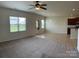 Spacious living area with a ceiling fan, and view of kitchen, ideal for entertaining at 1009 Dawn Light Rd, Indian Trail, NC 28079