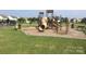 Community playground with slides and climbing structures, set on a wood-chip surface and surrounded by grassy area at 1009 Dawn Light Rd, Indian Trail, NC 28079