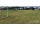 Community recreation field and pool area, featuring lush green grass with soccer goals and pool umbrellas in the distance at 1009 Dawn Light Rd, Indian Trail, NC 28079