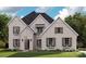 Charming brick home featuring symmetrical design, shuttered windows, and inviting curb appeal at 127 Palos Verde Rd, Mooresville, NC 28117