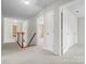 Upstairs hallway with carpet, wooden staircase, and doors to bedrooms at 235 Coralstone Dr, Fort Mill, SC 29708