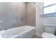 Clean bathroom with a bathtub, toilet, and tiled walls at 1770 Post Ct # Lot 510, Gastonia, NC 28054