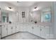 Bathroom featuring double vanity with white cabinetry, marble floors and decorative mirrors at 1770 Post Ct # Lot 510, Gastonia, NC 28054