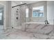 Luxurious bathroom featuring glass enclosed shower and soaking tub with marble tile surround at 1770 Post Ct # Lot 510, Gastonia, NC 28054