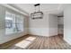 Dining room with large window, modern light fixture, and wood-look flooring at 1770 Post Ct # Lot 510, Gastonia, NC 28054