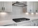 Close-up of the kitchen features a modern range hood, white backsplash tiles, and stainless steel appliances at 1770 Post Ct # Lot 510, Gastonia, NC 28054