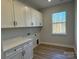 Laundry room with white cabinets and a window at 1770 Post Ct # Lot 510, Gastonia, NC 28054