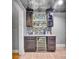 Basement bar area featuring tile backsplash, granite countertops, and wooden cabinets at 122 Long Cove Ln, Mooresville, NC 28117