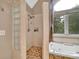 Modern bathroom featuring a large walk-in shower and jetted tub near a sun-filled window at 122 Long Cove Ln, Mooresville, NC 28117