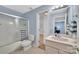 Well-lit bathroom with a shower, tub, and single sink vanity provides a clean and modern feel at 122 Long Cove Ln, Mooresville, NC 28117
