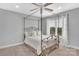 Bedroom with canopy bed, window, and neutral color scheme at 122 Long Cove Ln, Mooresville, NC 28117