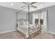 Bright bedroom with large window, metal framed canopy bed, and neutral decor at 122 Long Cove Ln, Mooresville, NC 28117