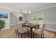 Formal dining area with stylish chairs, chandelier, and access to an outdoor balcony at 122 Long Cove Ln, Mooresville, NC 28117