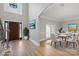 Elegant dining room featuring a table for six with arched entry and light hardwood floors at 122 Long Cove Ln, Mooresville, NC 28117