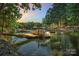 Picturesque waterfront featuring a private dock with boats and serene water views at 122 Long Cove Ln, Mooresville, NC 28117