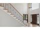 Elegant foyer with hardwood floors and staircase with iron accents at 122 Long Cove Ln, Mooresville, NC 28117