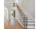 Grand foyer featuring hardwood floors, staircase with iron railing, and archway at 122 Long Cove Ln, Mooresville, NC 28117