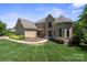 Charming home with manicured lawn, lush landscaping, and a welcoming entrance at 122 Long Cove Ln, Mooresville, NC 28117