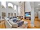 Two-story Gathering room with stone fireplace, hardwood floors, and large windows at 122 Long Cove Ln, Mooresville, NC 28117