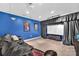 Basement home theater with seating, large screen and dark blue walls at 122 Long Cove Ln, Mooresville, NC 28117