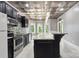 Well-lit kitchen with stainless steel appliances, granite countertops and a metallic patterned ceiling at 122 Long Cove Ln, Mooresville, NC 28117