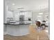 Modern kitchen featuring white cabinets, island, and hardwood flooring, plus a breakfast area at 122 Long Cove Ln, Mooresville, NC 28117