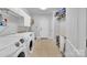 Bright laundry room with modern washer and dryer, ample storage, and convenient access to the outside at 122 Long Cove Ln, Mooresville, NC 28117