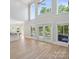 Open living space with tall windows, hardwood floors, and great lighting at 122 Long Cove Ln, Mooresville, NC 28117