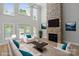 Bright living room with fireplace, large windows, and neutral furnishings at 122 Long Cove Ln, Mooresville, NC 28117