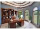 Elegant home office with custom built-ins, coffered ceiling, and natural light at 122 Long Cove Ln, Mooresville, NC 28117