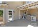 Outdoor kitchen with stainless steel grill, mini-fridge and a Tiki Bar sign at 122 Long Cove Ln, Mooresville, NC 28117