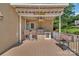 Covered patio with outdoor kitchen, tiki bar, and grill at 122 Long Cove Ln, Mooresville, NC 28117