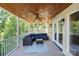 Inviting screened porch with comfortable seating and a ceiling fan at 122 Long Cove Ln, Mooresville, NC 28117