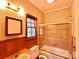 Bathroom with shower/tub combo and wood-paneled walls at 1506 Dallas Cherryville Hwy, Dallas, NC 28034